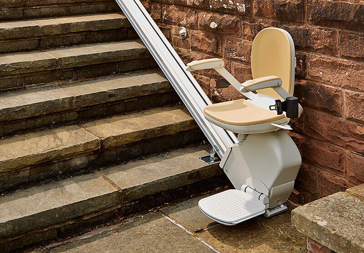 Outdoor stairlift installed beside stone steps